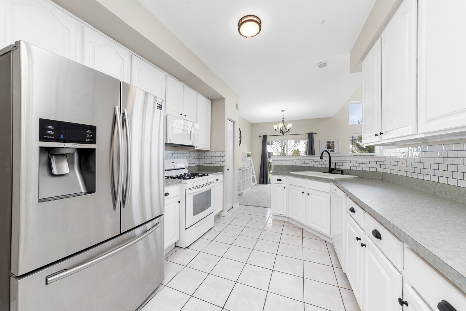1020 Key Largo Drive Romeoville, IL 60446 - Photo 2 of 22 a kitchen with white cabinets and white appliances