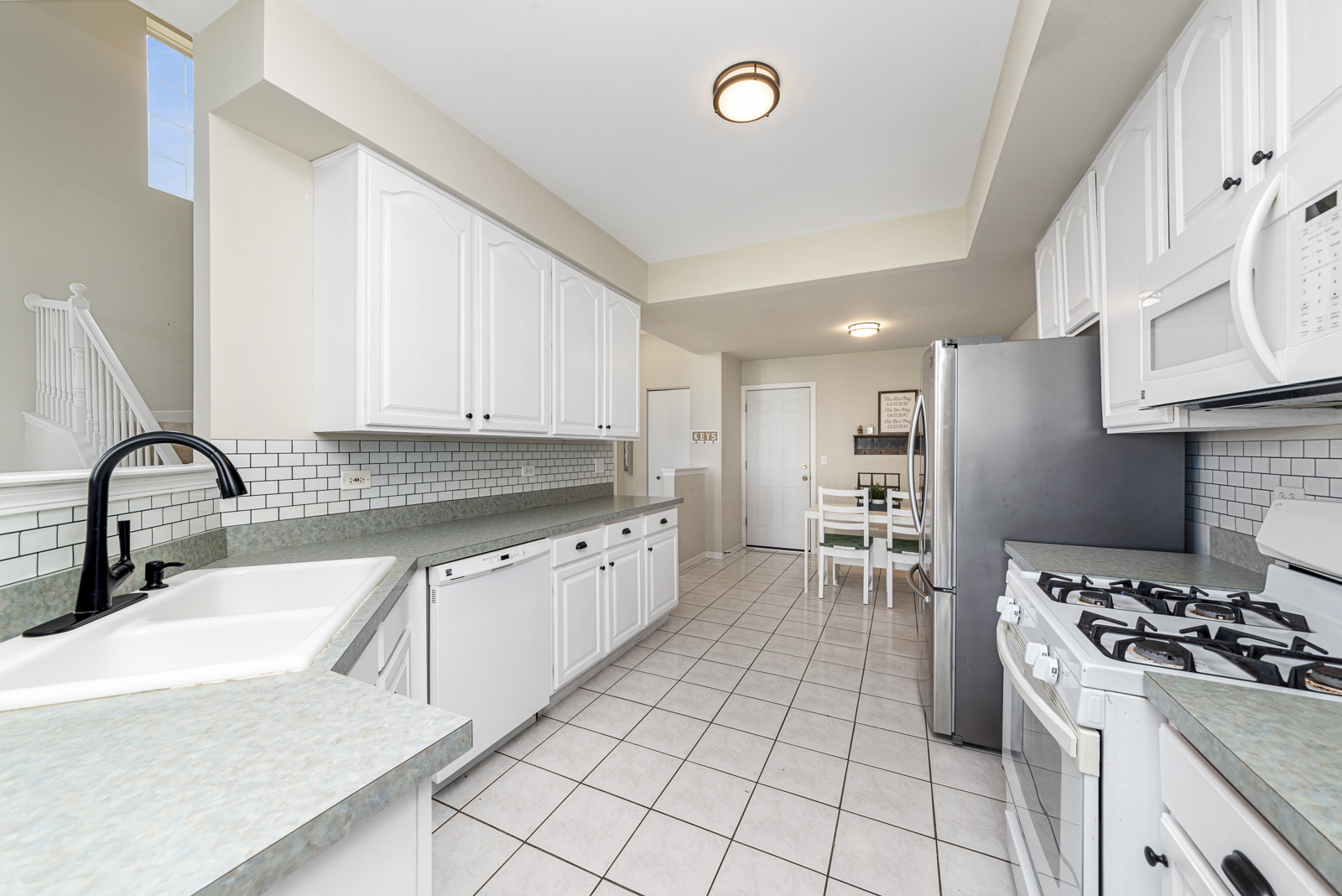 1020 Key Largo Drive Romeoville, IL 60446 - Photo 4 of 22 a kitchen with granite countertop a sink stainless steel appliances and cabinets