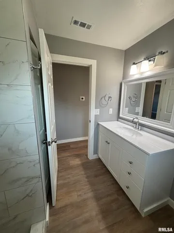 a spacious bathroom with a double vanity sink and a mirror