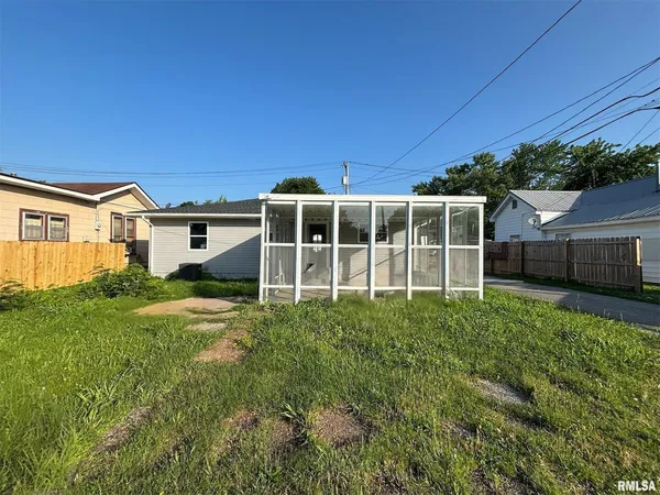 a view of a house with backyard sitting area and garden