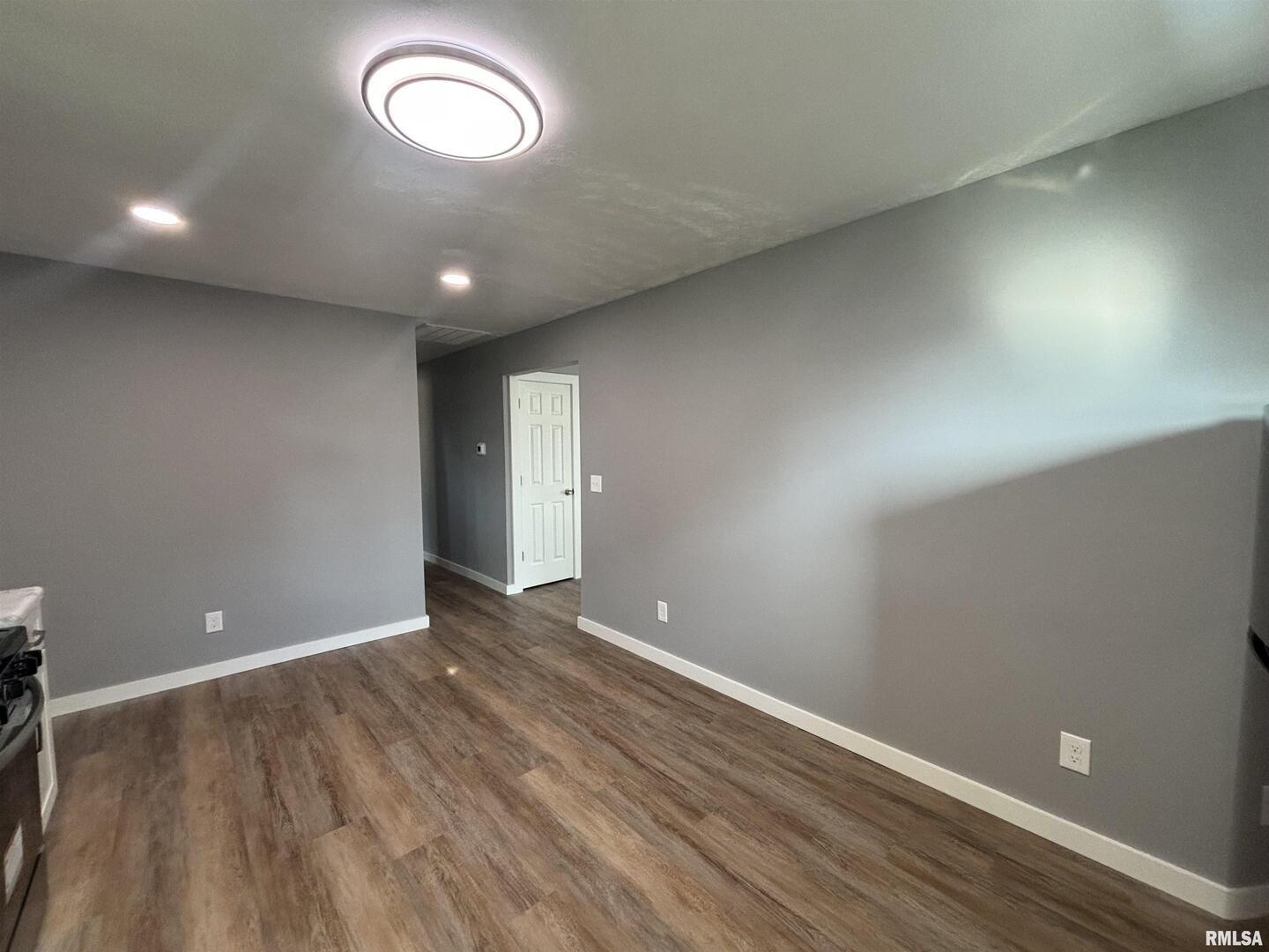 710 Catherine Street Metropolis, IL 62960 - Photo 8 of 18 an empty room with wooden floor and windows