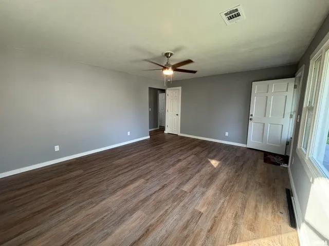 wooden floor in an empty room with a window
