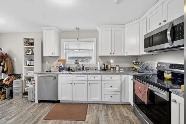 a kitchen with stainless steel appliances a stove a refrigerator and cabinets
