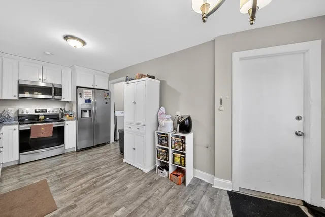 a view of a livingroom with furniture and a flat screen tv