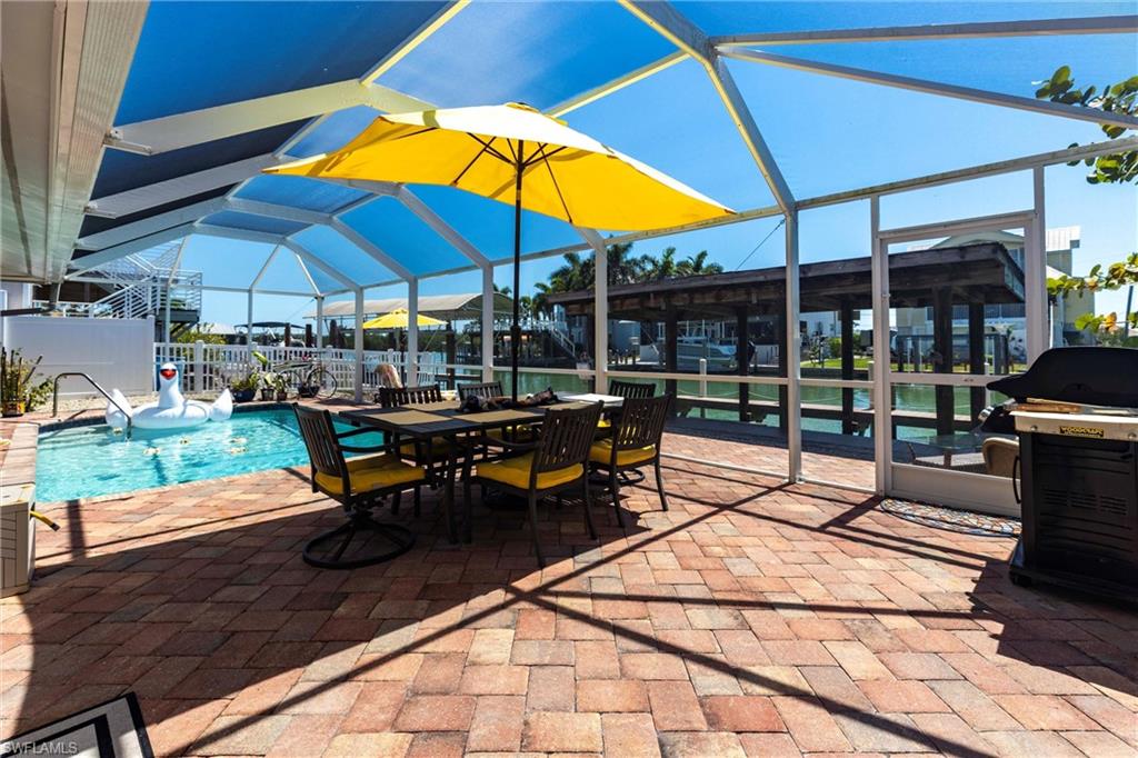 164 Trinidad Street Naples, FL 34113 - Photo 12 of 43 a view of chairs and tables in the patio