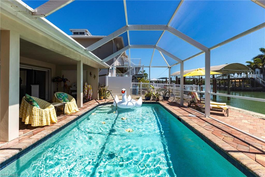 164 Trinidad Street Naples, FL 34113 - Photo 13 of 43 a view of a backyard with swimming pool