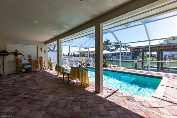 a view of a porch with chairs and backyard