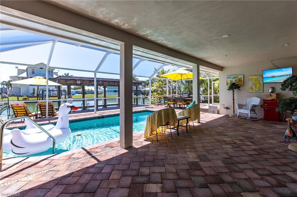 164 Trinidad Street Naples, FL 34113 - Photo 16 of 43 a view of a porch with chairs and backyard