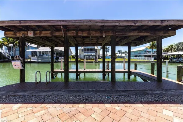 a view of porch with a table and chairs