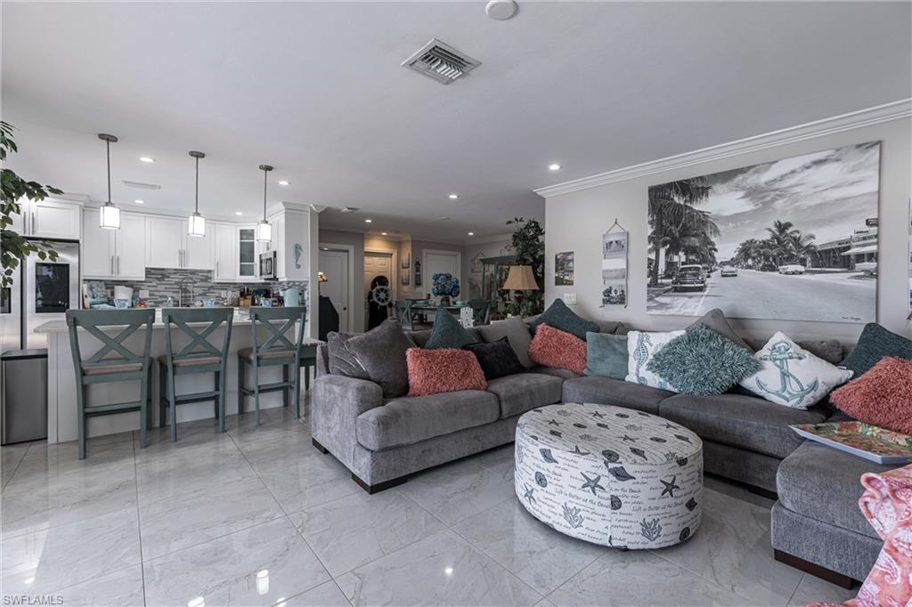 164 Trinidad Street Naples, FL 34113 - Photo 23 of 43 a living room with furniture and a large window