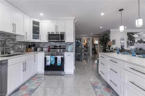 a kitchen with stainless steel appliances granite countertop a stove and cabinets
