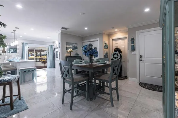 a view of a dining room with furniture and chandelier