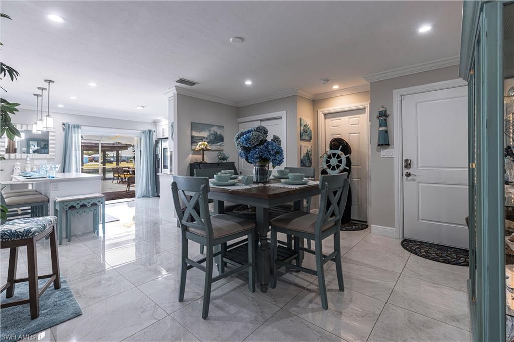164 Trinidad Street Naples, FL 34113 - Photo 29 of 43 a view of a dining room with furniture