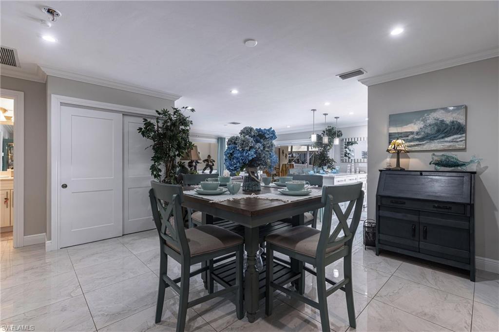 164 Trinidad Street Naples, FL 34113 - Photo 31 of 43 a kitchen with a table and chairs in it