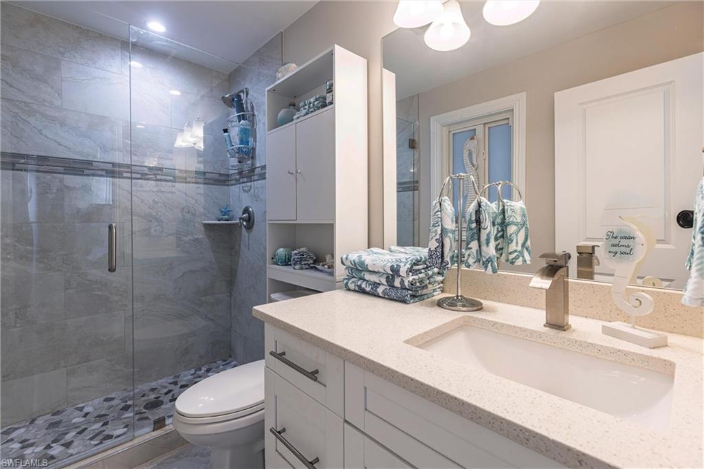 164 Trinidad Street Naples, FL 34113 - Photo 35 of 43 a bathroom with a sink toilet and shower