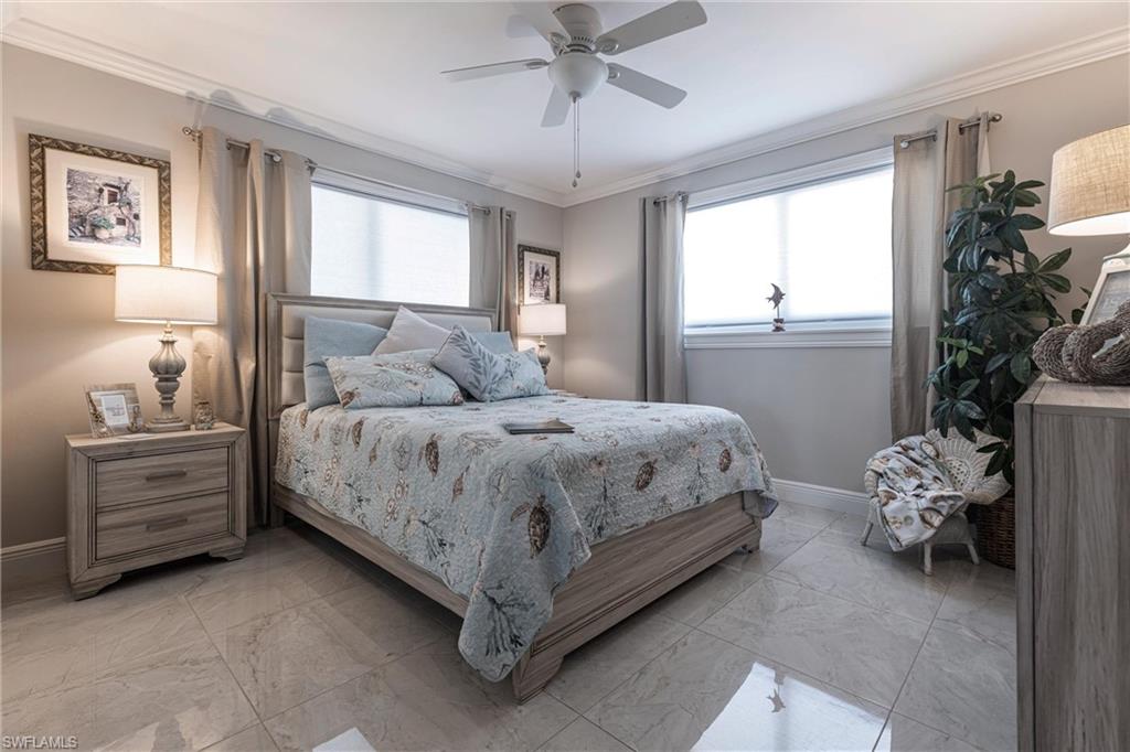 164 Trinidad Street Naples, FL 34113 - Photo 36 of 43 a bedroom with a bed and a window