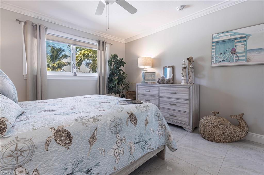 164 Trinidad Street Naples, FL 34113 - Photo 37 of 43 a bedroom with a bed and a window
