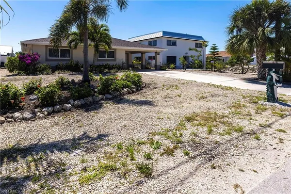 a front view of house with yard outdoor seating and barbeque oven