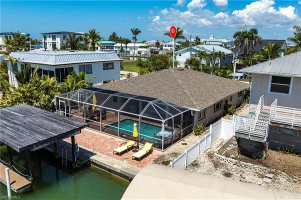 a view of a patio with table and chairs a barbeque