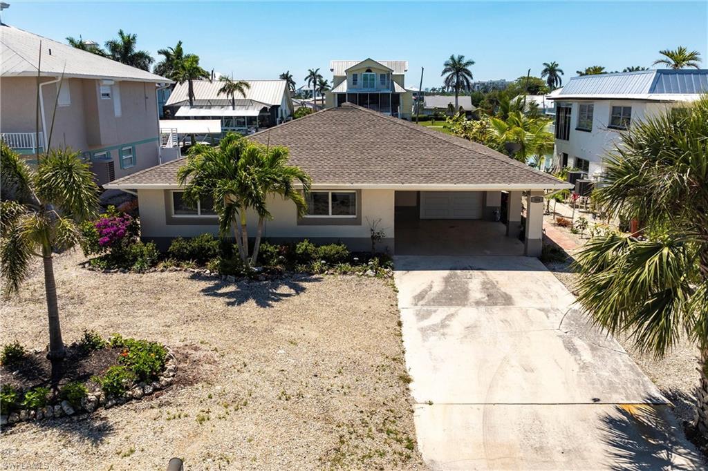 164 Trinidad Street Naples, FL 34113 - Photo 42 of 43 a view of a house with a yard