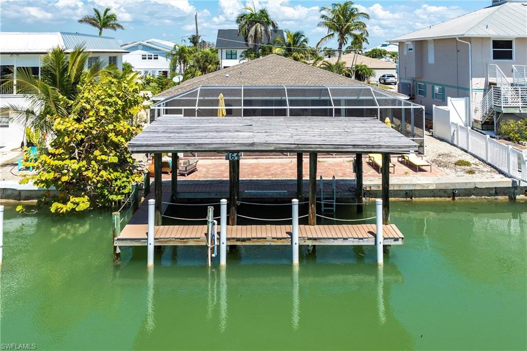 164 Trinidad Street Naples, FL 34113 - Photo 5 of 43 a white house with a yard and sitting area