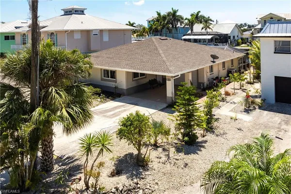 an aerial view of a house with a yard and sitting area