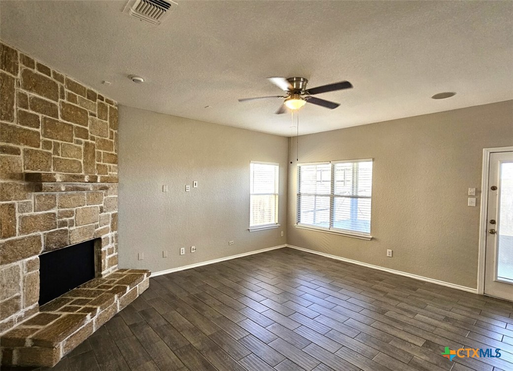 316 Julian Point Cibolo, TX 78108 - Photo 8 of 28 a view of an empty room with a fireplace and a window