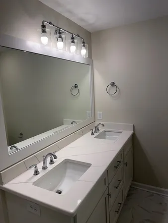 a bathroom with a sink double vanity and mirror
