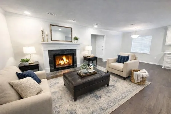 a living room with furniture and a fireplace