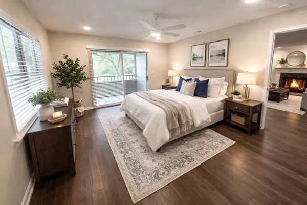 a bed sitting in a spacious bedroom next to a window