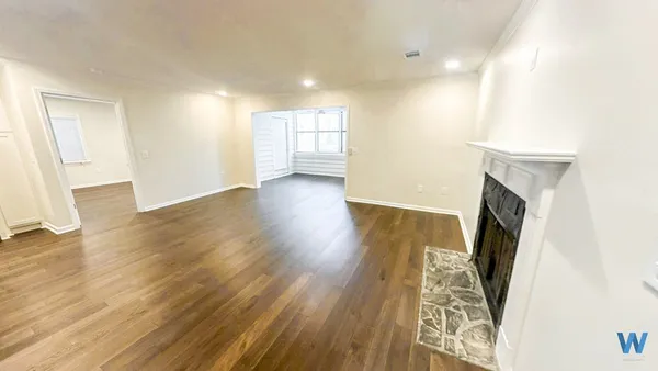 wooden floor in an empty room with a fireplace