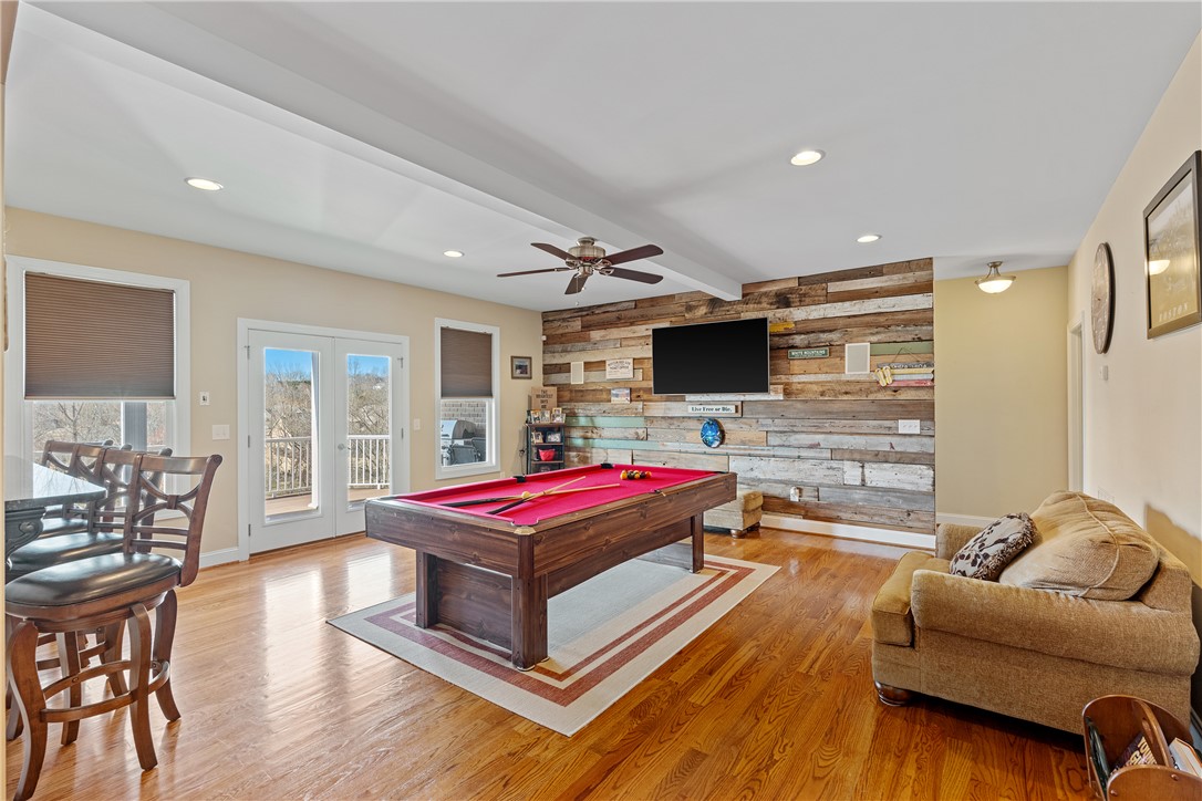 119 Turnberry Road Anderson, SC 29621 - Photo 28 of 50 This versatile room features warm hardwood floors and a striking wood-paneled accent wall, perfect for recreation.
