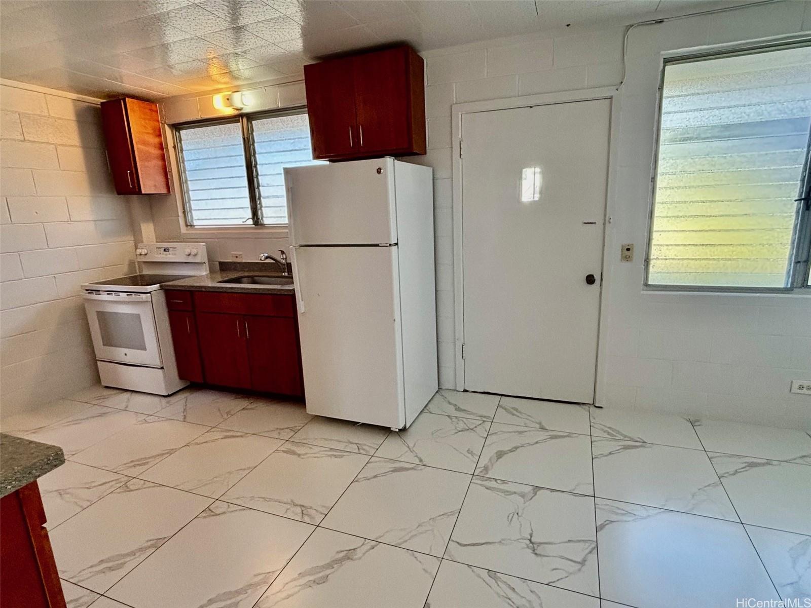 608 Judd Street, Unit A Honolulu, HI 96817 - Photo 2 of 13 a kitchen with stainless steel appliances granite countertop a refrigerator a stove a sink and a granite counter tops