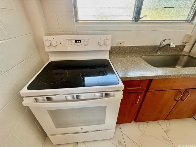 a stove top oven sitting inside of a kitchen