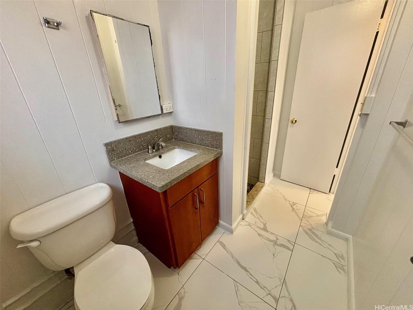 608 Judd Street, Unit A Honolulu, HI 96817 - Photo 6 of 13 a bathroom with a toilet sink and mirror
