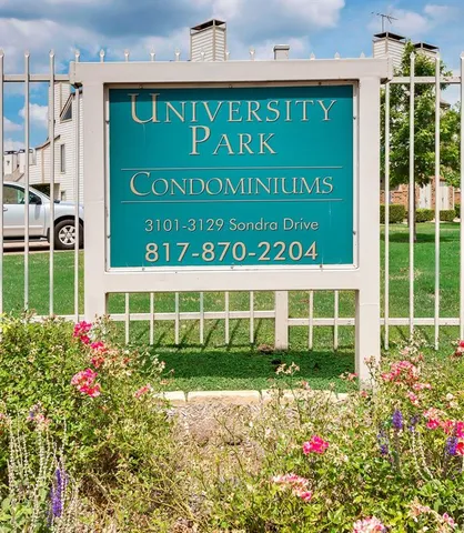 a sign that is in front of flowers