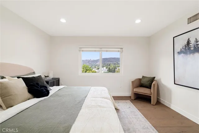 a bedroom with a bed and a couch