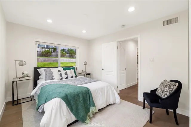 a bedroom with a bed and a chair