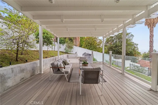 a balcony with furniture and wooden floor