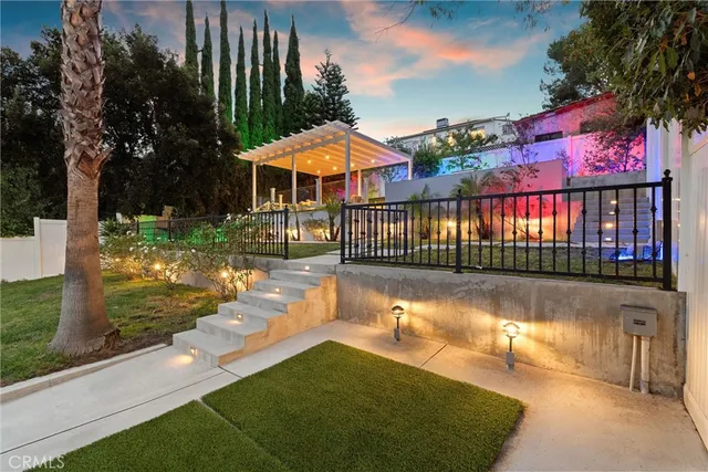 a view of a house with backyard and sitting area
