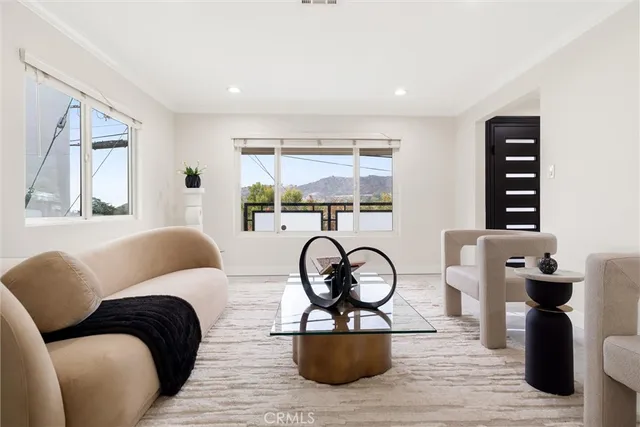 a living room with furniture a window and a fireplace