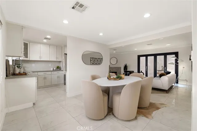 a open kitchen with stainless steel appliances granite countertop a sink and white cabinets