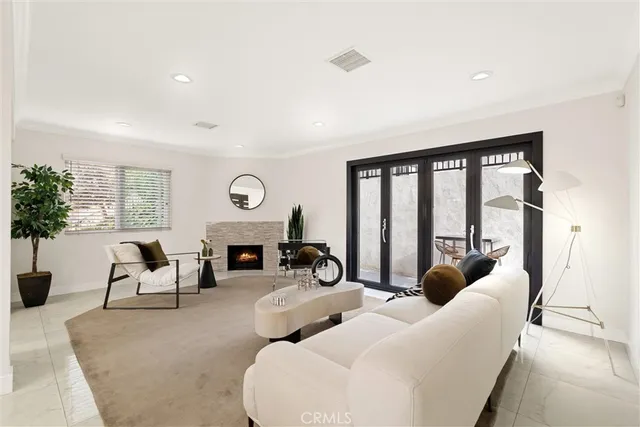 a living room with furniture large window and a fireplace