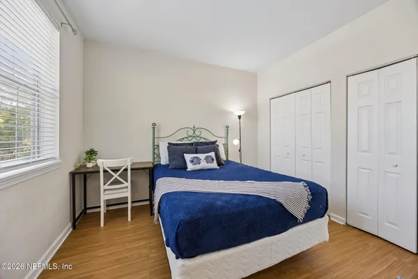 a bedroom with a bed and a couch