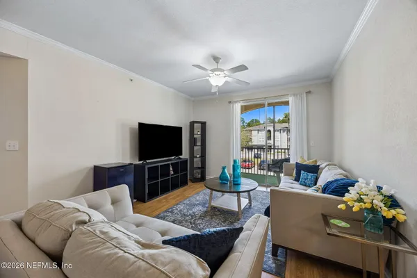 a living room with furniture and a flat screen tv