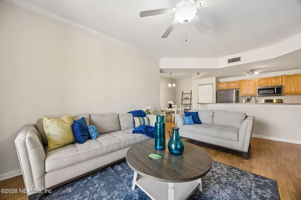a living room with furniture and a chandelier
