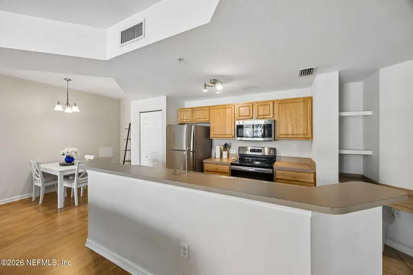 a large kitchen with a table and chairs