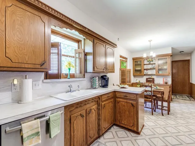 a kitchen with granite countertop sink cabinets and stainless steel appliances