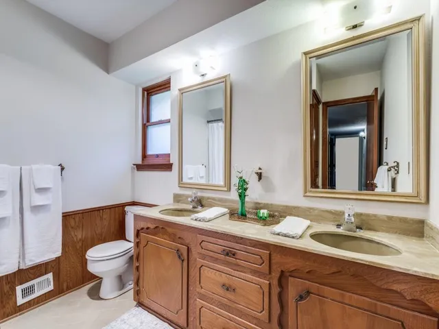 a bathroom with a toilet a sink and a mirror