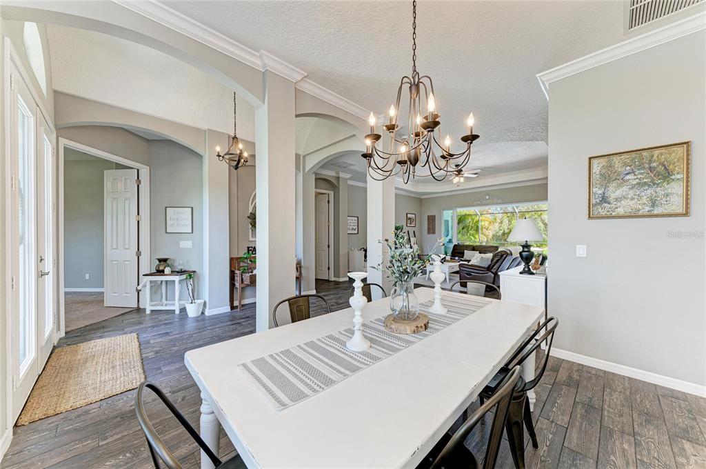16336 26th Street East Parrish, FL 34219 - Photo 12 of 69 a view of a dining room with furniture a chandelier and wooden floor